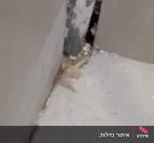 סדק בקיר ליד צינור מתכת